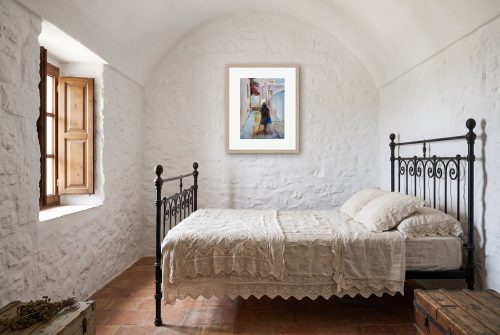 «La Cuesta», cuadro original de Alicia Prado, colgado en dormitorio en una casa encalada de Frigiliana